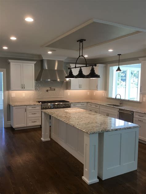 white recessed panel cabinets with stainless steel appliances|stainless steel off white kitchen.